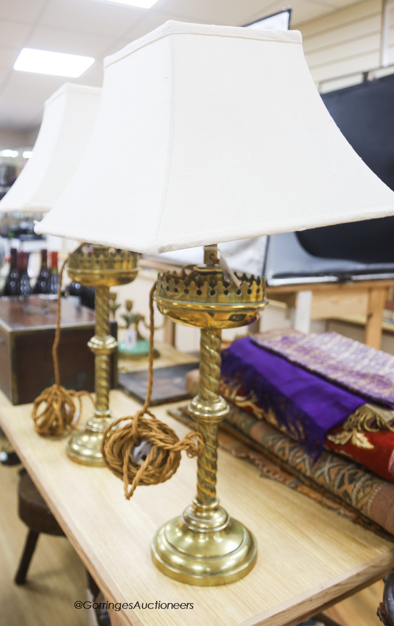 A pair of ecclesiastical brass lamps, later converted, height 37cm